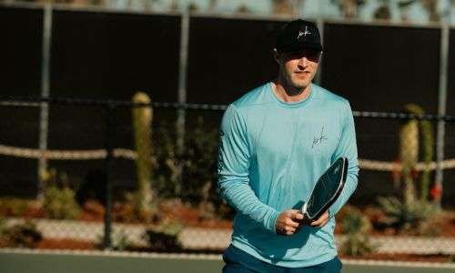 pickleball coach standing and giving pose at court