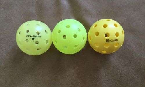 3 different colors of ONIX Dura Fast 40 pickleball balls on surface
